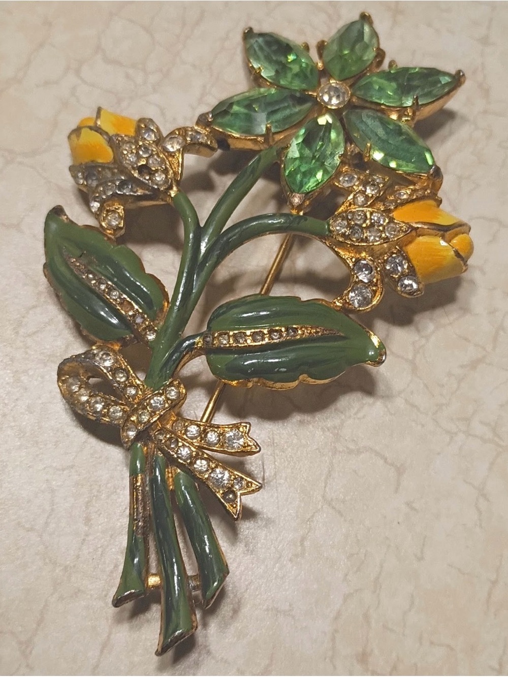 Vintage 1930-1960 figural bouquet brooch features gold-tone metal, green enamel